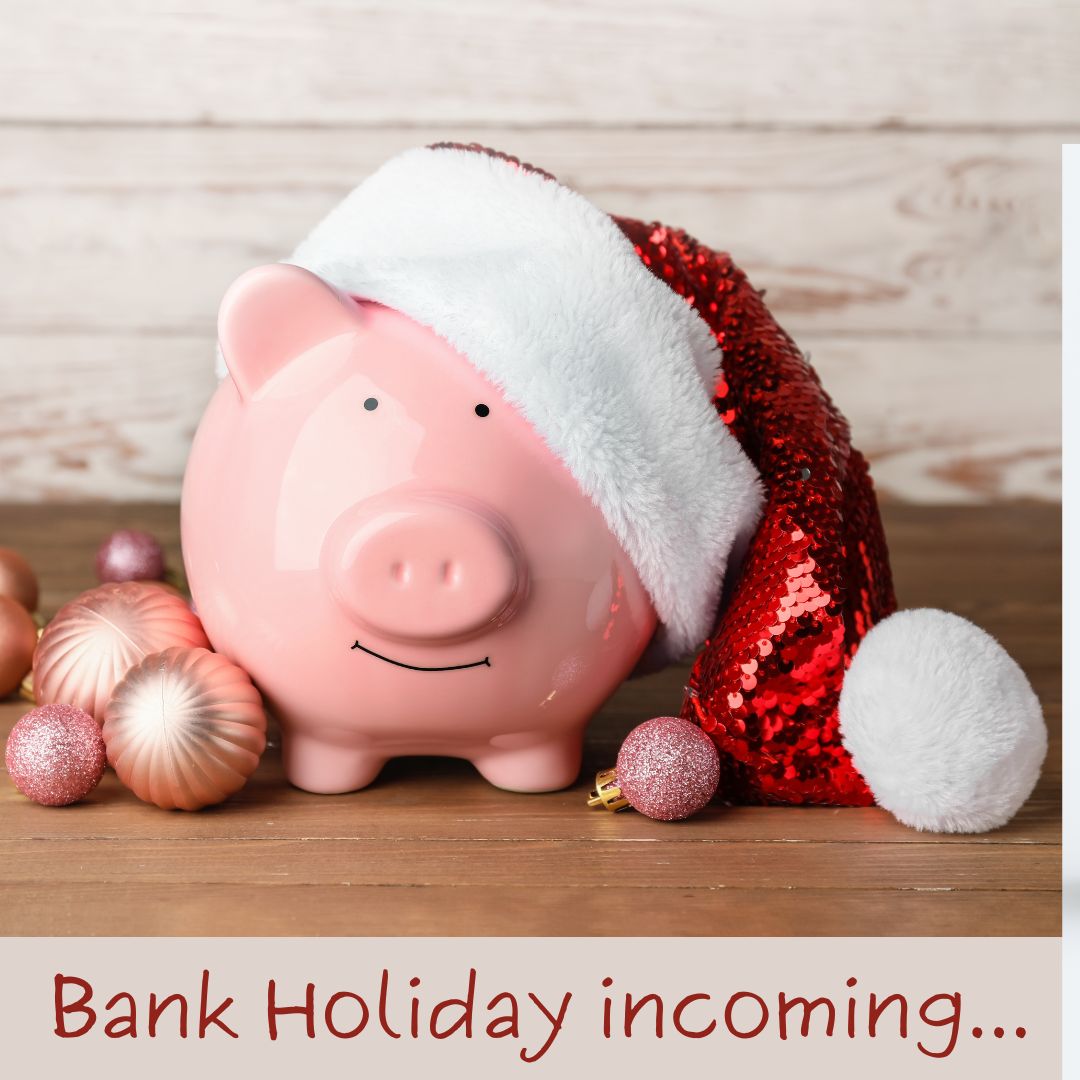 Photo of piggy bank wearing Santa hat