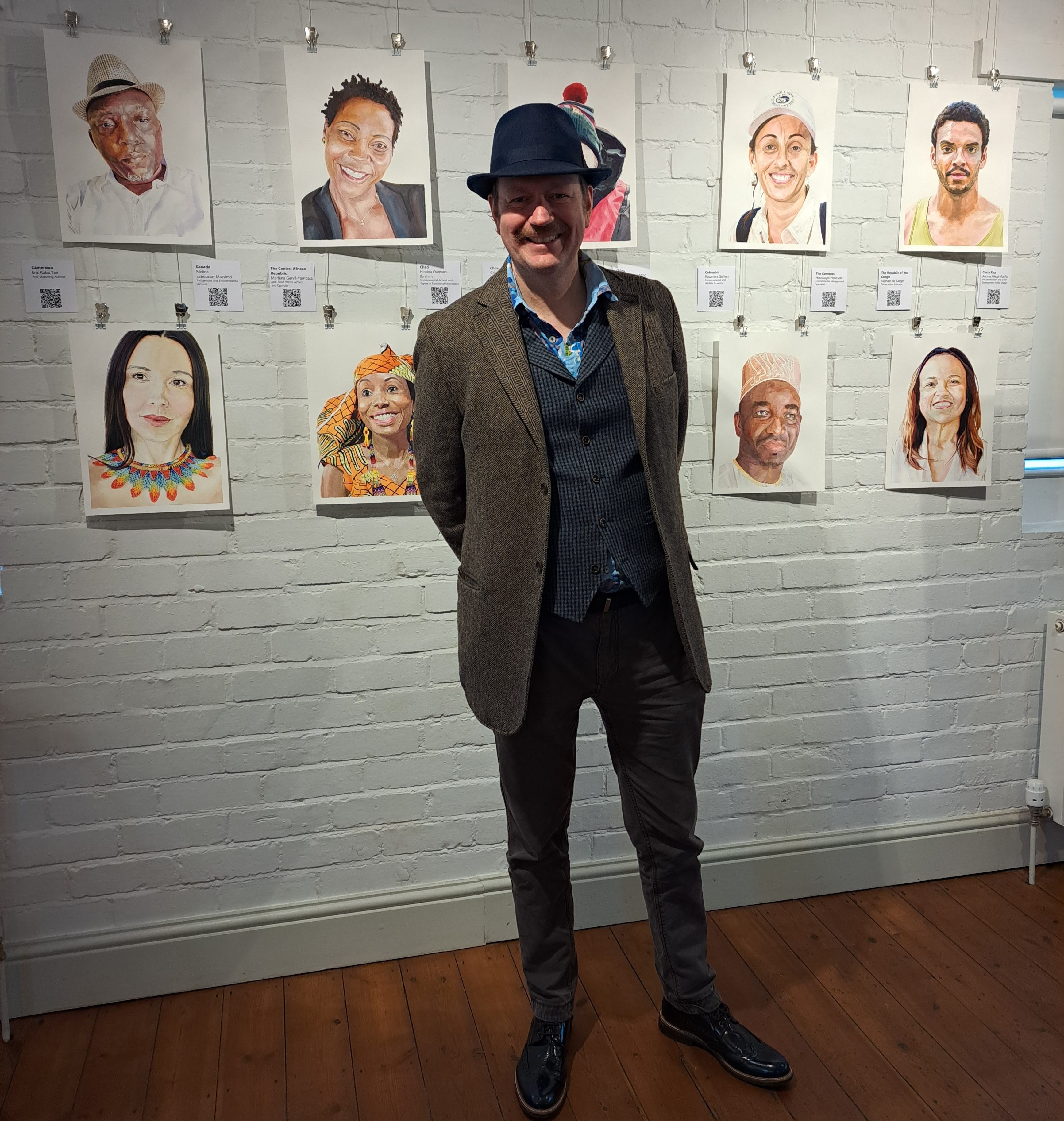 photo of James Nickells in front of pictures