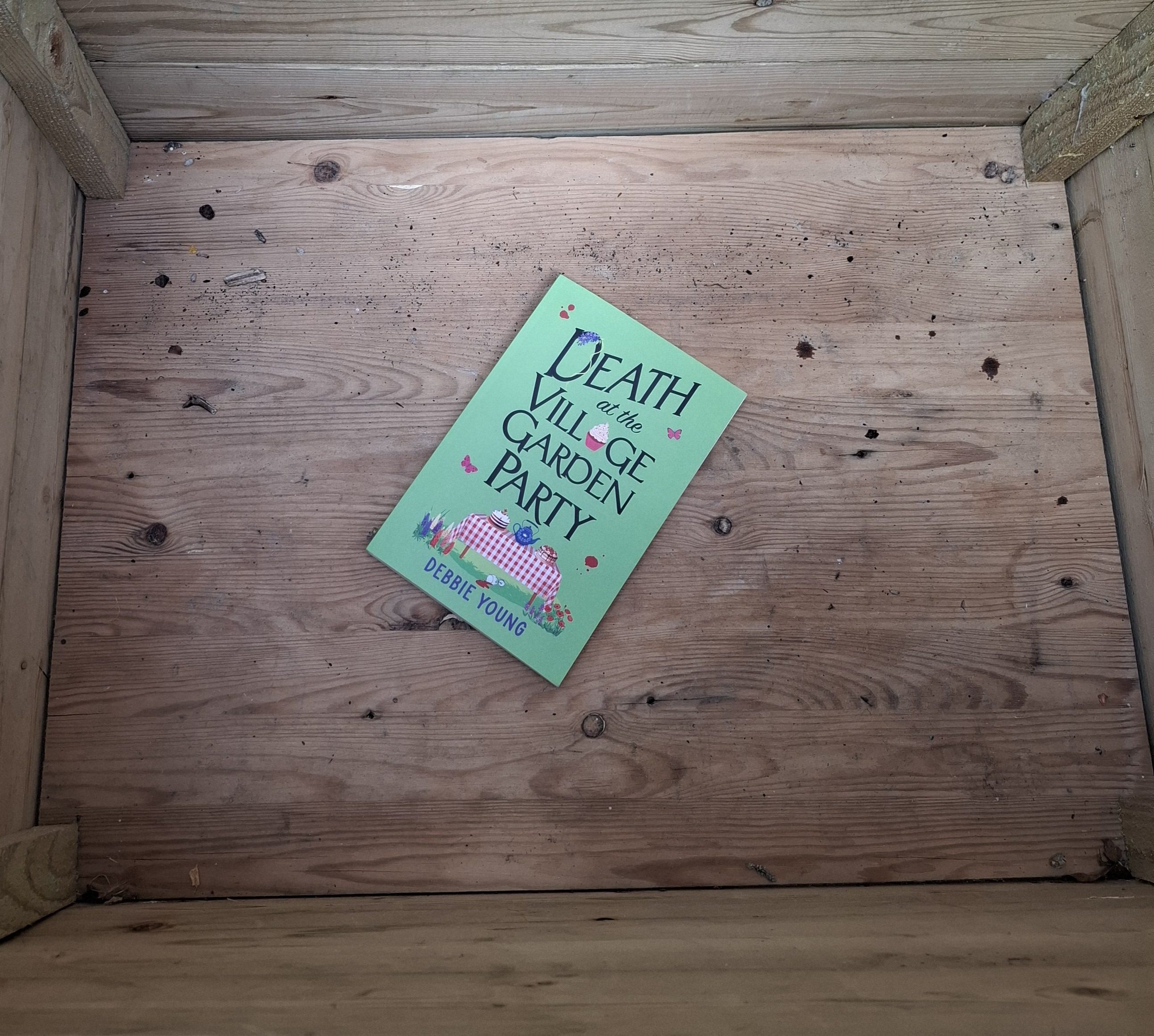 copy of Death at the Village Garden Party inside parcel box